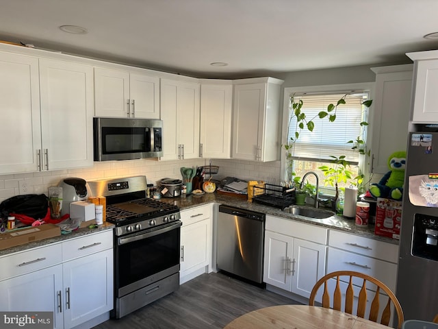 kitchen featuring stainless steel appliances, white cabinetry, and sink