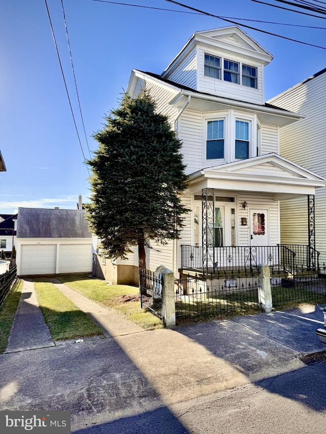 front of property featuring a porch, an outdoor structure, and a garage