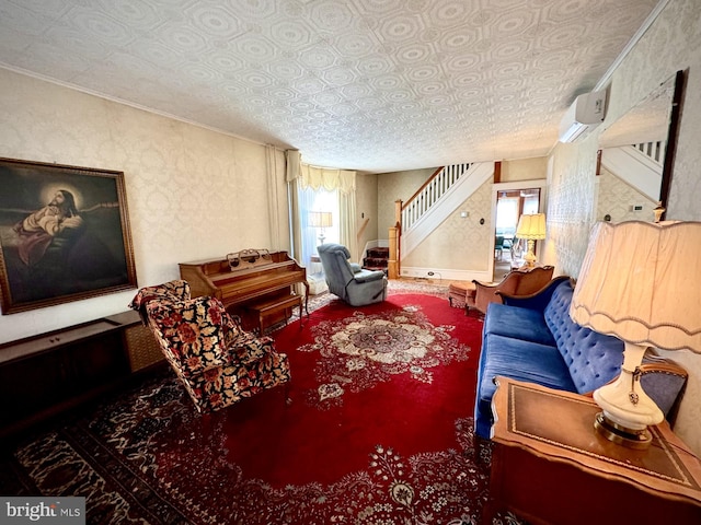 living room with a wall mounted air conditioner and a textured ceiling