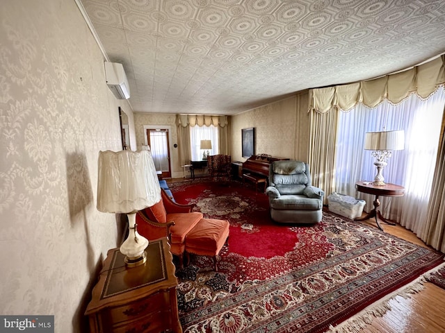 living room featuring hardwood / wood-style flooring and a wall mounted air conditioner