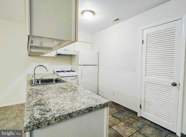 kitchen with sink and white appliances