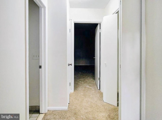 corridor featuring light colored carpet