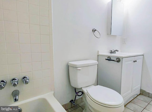 full bathroom with tile patterned floors, vanity, toilet, and tiled shower / bath combo