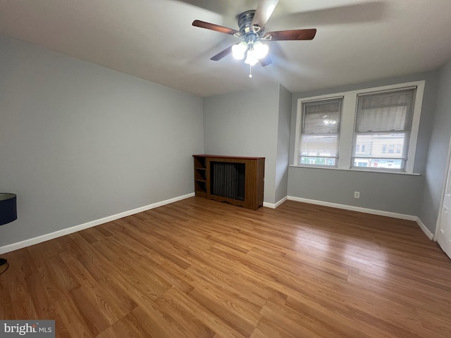 unfurnished living room featuring light hardwood / wood-style floors and ceiling fan