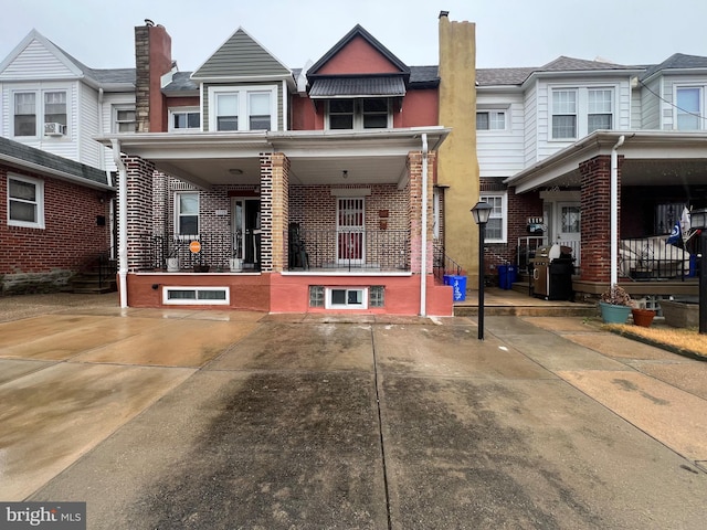 townhome / multi-family property featuring a porch