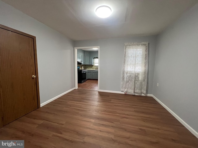 empty room featuring dark hardwood / wood-style flooring