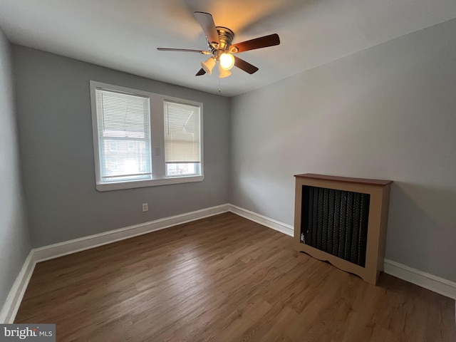 unfurnished room with dark hardwood / wood-style floors and ceiling fan