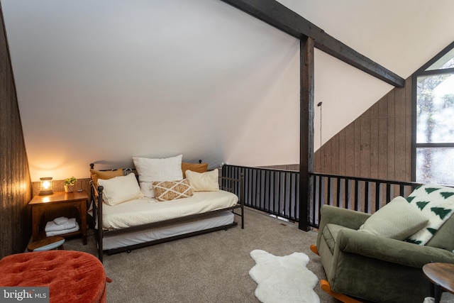 carpeted bedroom with beamed ceiling, high vaulted ceiling, and wooden walls