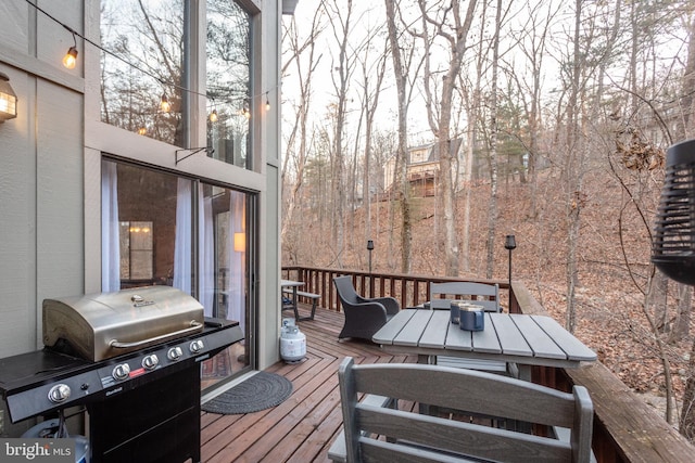 wooden terrace featuring a grill