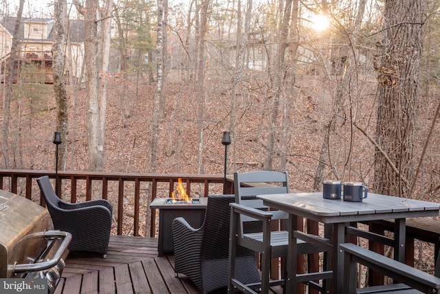 wooden terrace with a fire pit