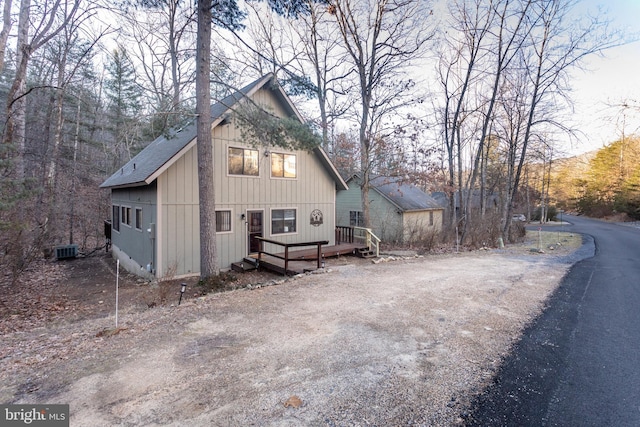 view of side of property featuring central air condition unit and a deck