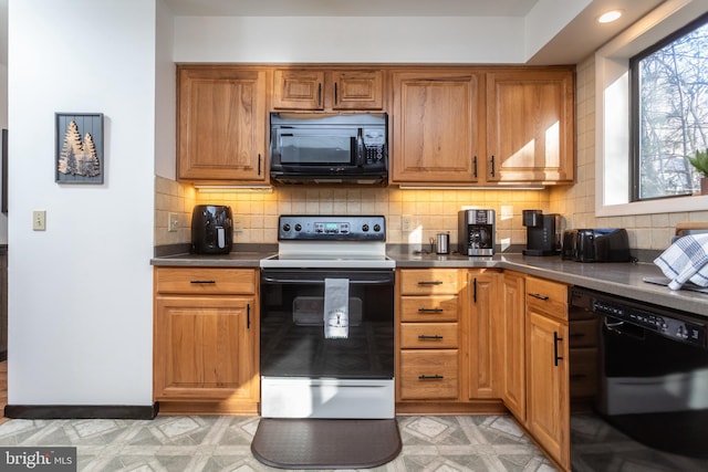 kitchen with black appliances and backsplash