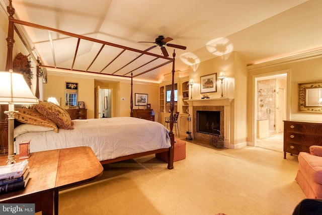 carpeted bedroom featuring ensuite bath, ceiling fan, crown molding, and vaulted ceiling