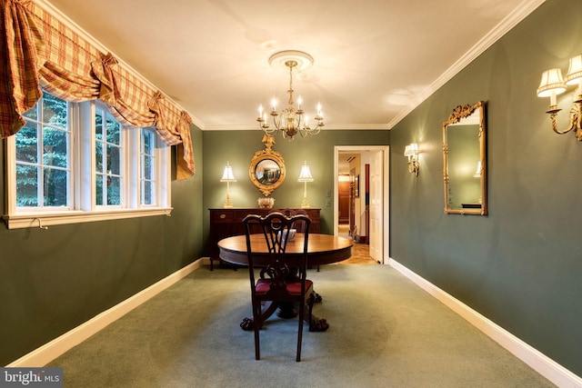 dining room with carpet flooring, ornamental molding, and a notable chandelier