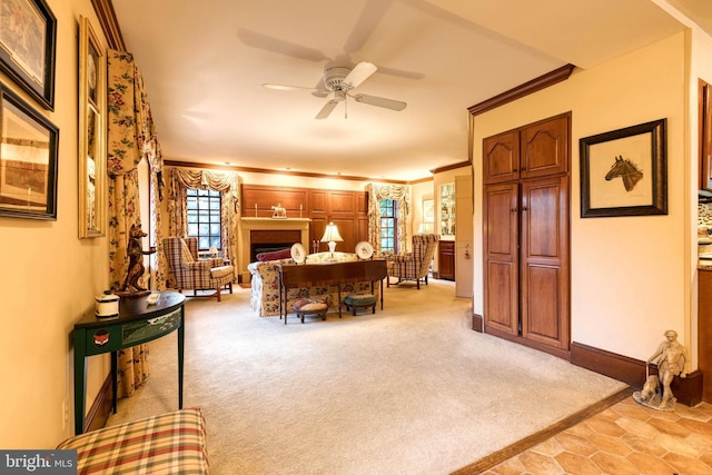 interior space with light colored carpet, ceiling fan, and crown molding