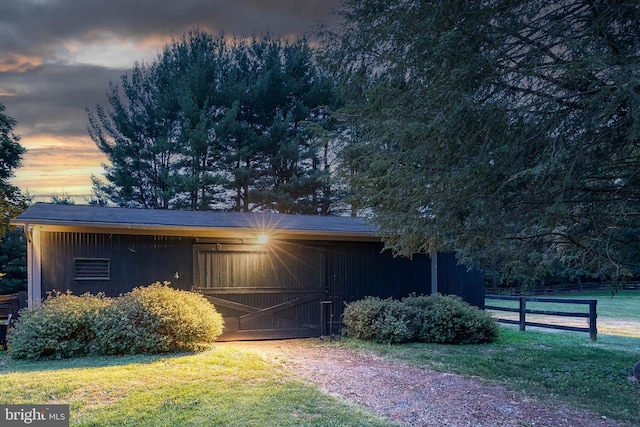 exterior space featuring an outbuilding and a lawn