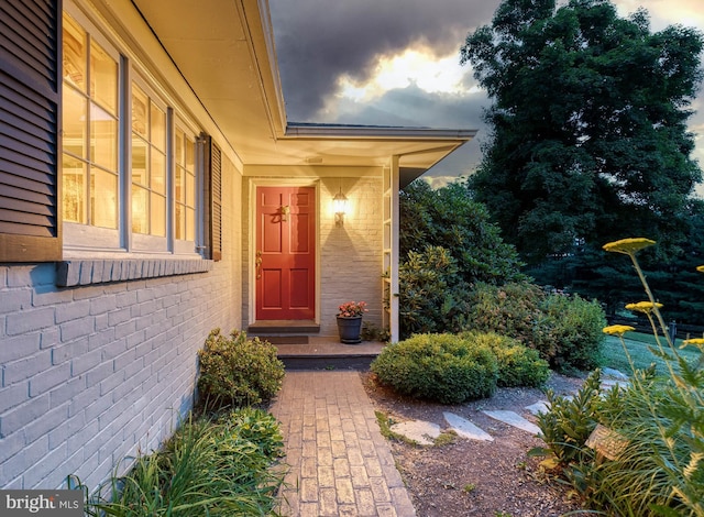 view of exterior entry at dusk