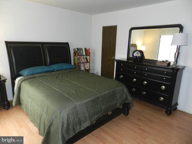 bedroom with hardwood / wood-style flooring