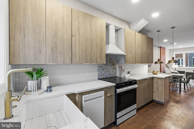 kitchen featuring electric range, pendant lighting, dark hardwood / wood-style floors, decorative backsplash, and wall chimney exhaust hood