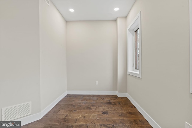 spare room with dark wood-type flooring