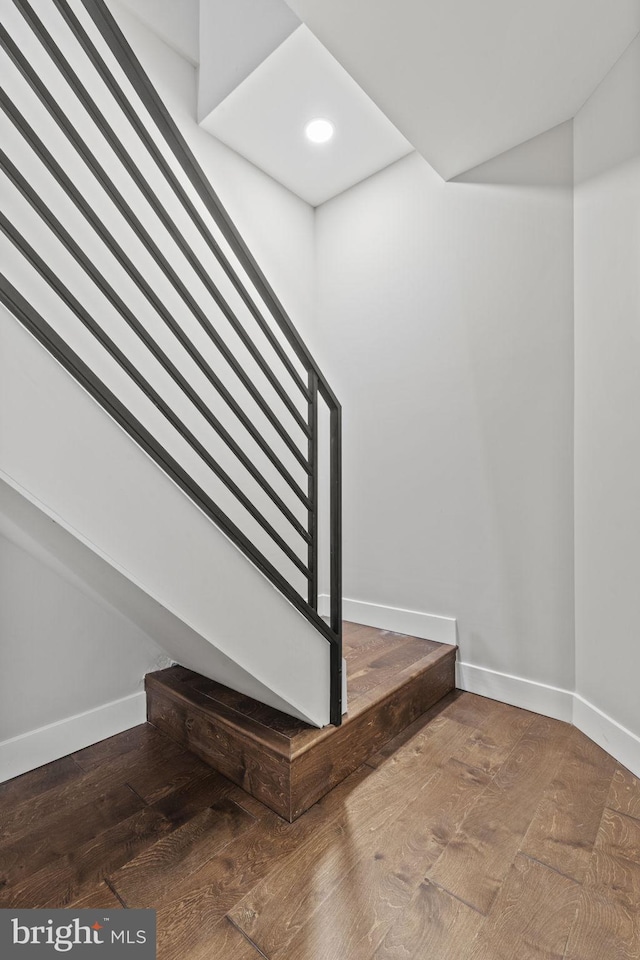 stairway with hardwood / wood-style floors