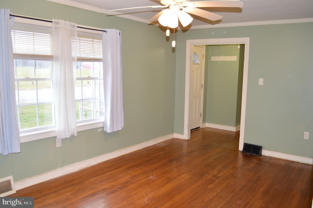 unfurnished room with plenty of natural light, ceiling fan, ornamental molding, and dark wood-type flooring