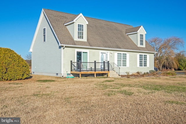 rear view of house with a wooden deck and a yard