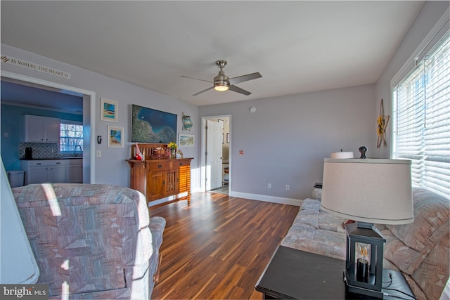 living room with ceiling fan, dark hardwood / wood-style floors, and sink