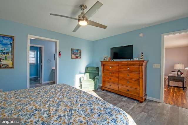 bedroom featuring ceiling fan, hardwood / wood-style floors, and ensuite bath