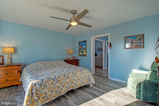 bedroom featuring dark wood-type flooring, ceiling fan, and connected bathroom