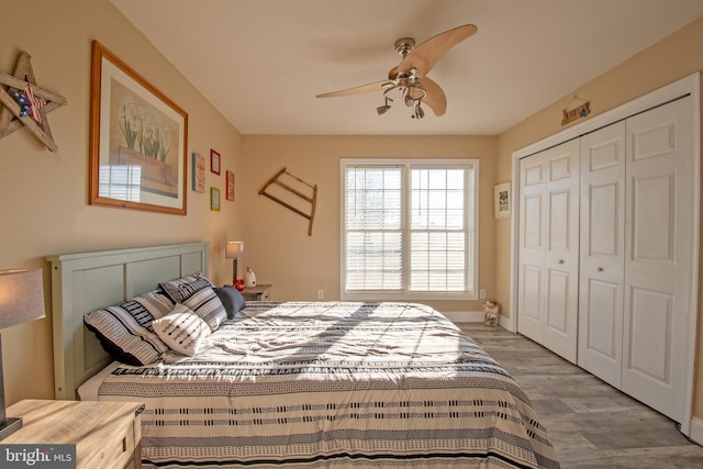 bedroom featuring ceiling fan, a closet, and hardwood / wood-style floors