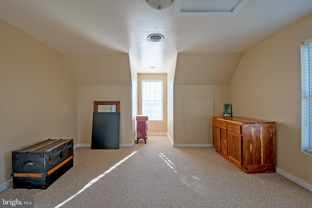 bonus room featuring lofted ceiling and light colored carpet