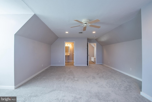 bonus room with ceiling fan, vaulted ceiling, and light carpet