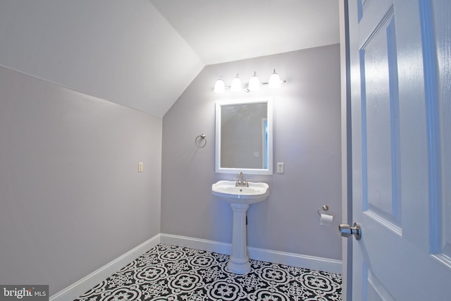 bathroom featuring tile patterned flooring and vaulted ceiling