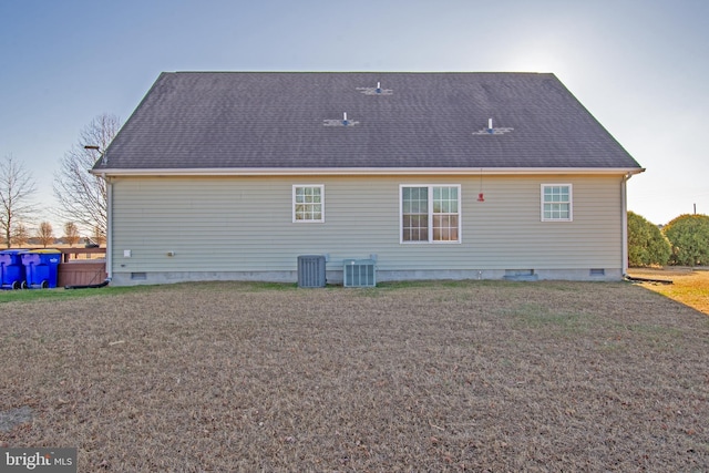 rear view of house featuring central air condition unit