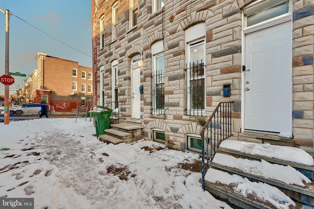 view of snow covered property entrance