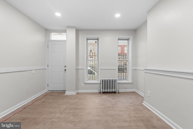 empty room with plenty of natural light and radiator heating unit