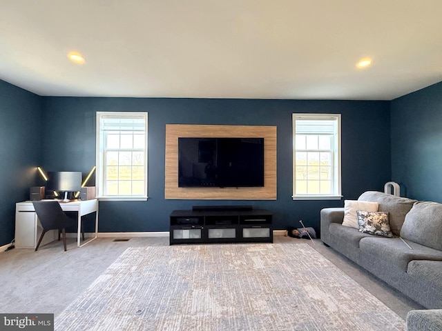 carpeted living room with a healthy amount of sunlight