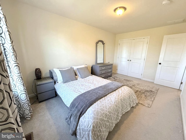 carpeted bedroom featuring a closet