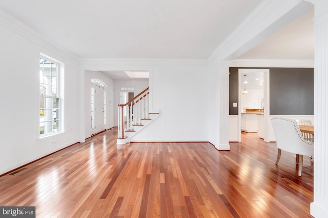 interior space with hardwood / wood-style flooring and ornamental molding