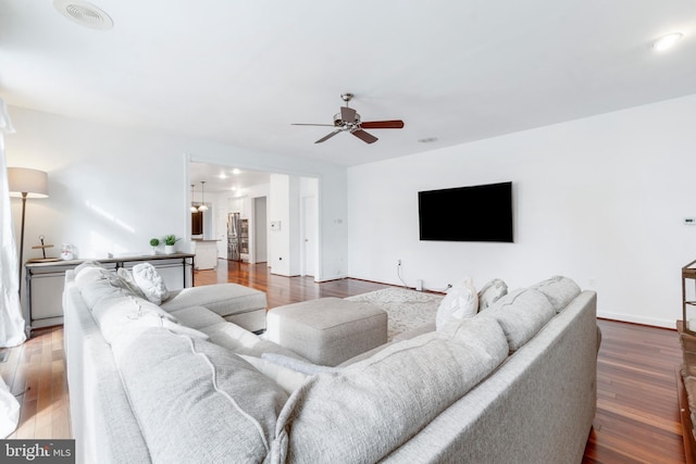 living room with ceiling fan and wood-type flooring