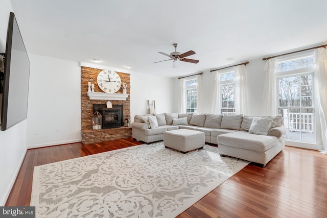 living room with ceiling fan and hardwood / wood-style flooring