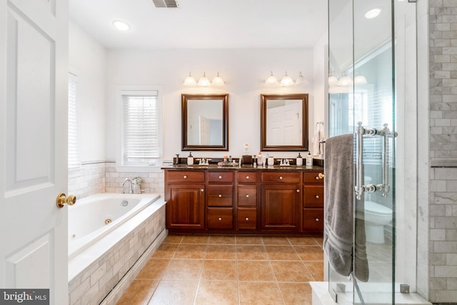 full bathroom with tile patterned floors, vanity, toilet, and shower with separate bathtub