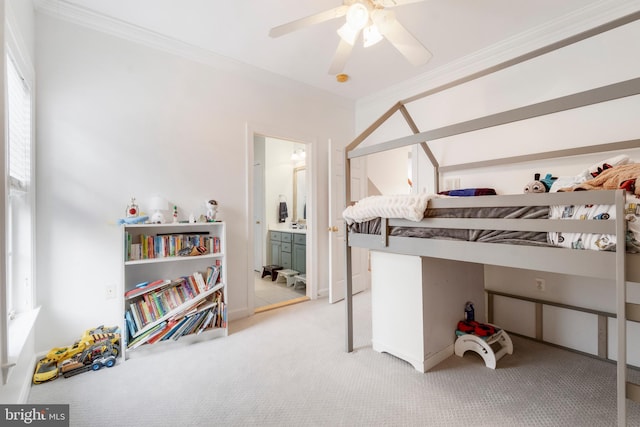 bedroom with ceiling fan, ornamental molding, carpet floors, and connected bathroom