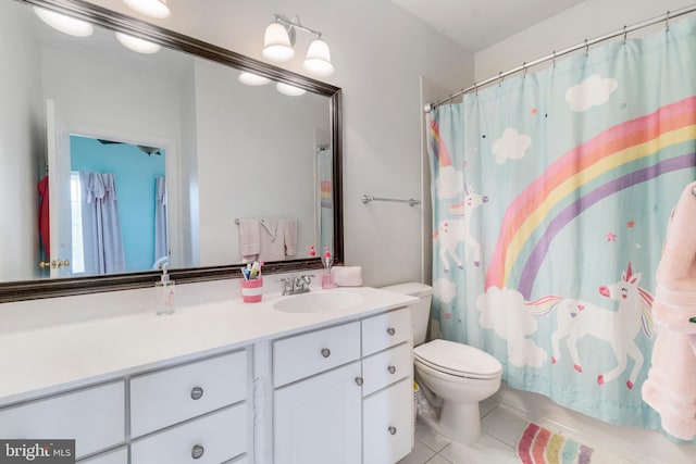 bathroom featuring tile patterned floors, vanity, curtained shower, and toilet