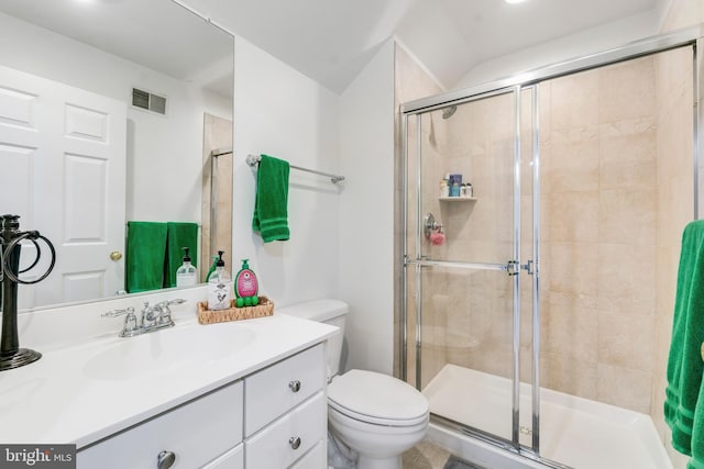 bathroom featuring vanity, toilet, and a shower with shower door