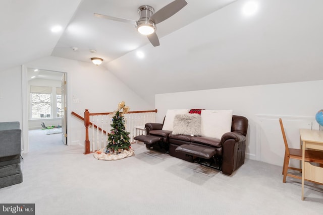 sitting room featuring ceiling fan, light carpet, and lofted ceiling