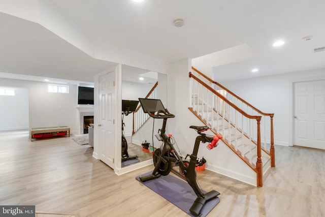 workout room featuring light hardwood / wood-style flooring