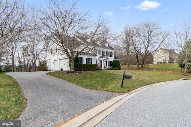 view of front of house featuring a garage and a front yard