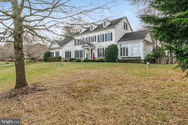 colonial-style house with a front yard